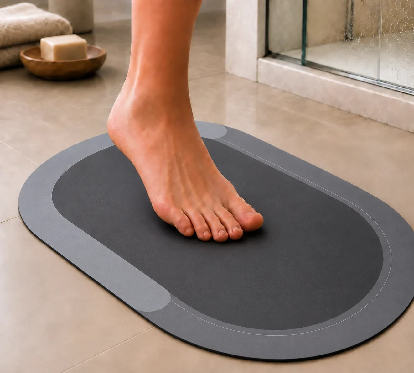Bare foot on the soft, thin charcoal DryFloor mat